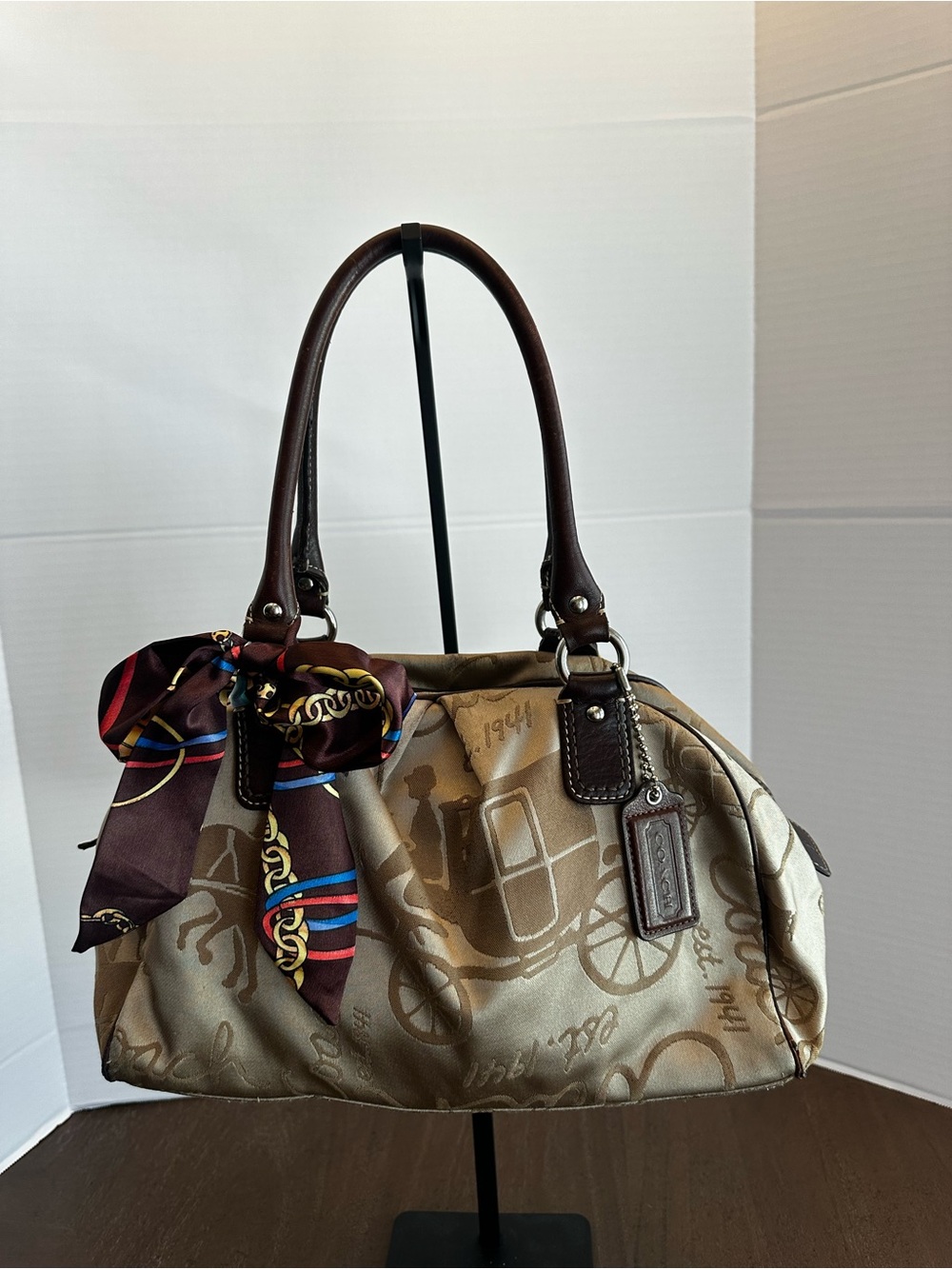 Coach Satchel printed with a vintage "Horse and Carriage" motif